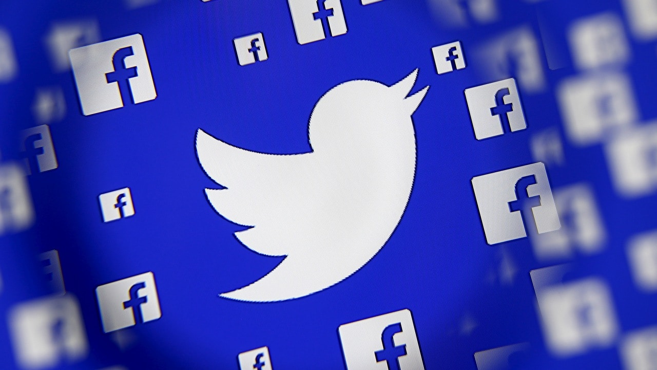 Logo of the Twitter and Facebook are seen through magnifier on display in this illustration taken in Sarajevo, Bosnia and Herzegovina, December 16, 2015. Broker's survey shows Twitter losing share to faster growing competitors such as Facebook's Instagram and Snapchat, despite co's multiple product and partnership launches this year, analysts write in note. REUTERS/Dado Ruvic - GF10000268362