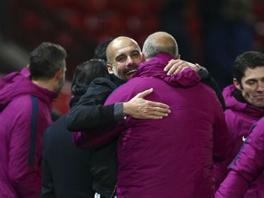 Manchester City boss Pep Guardiola celebrates with his coaching staff after beating Manchester United at Old Trafford. AFP