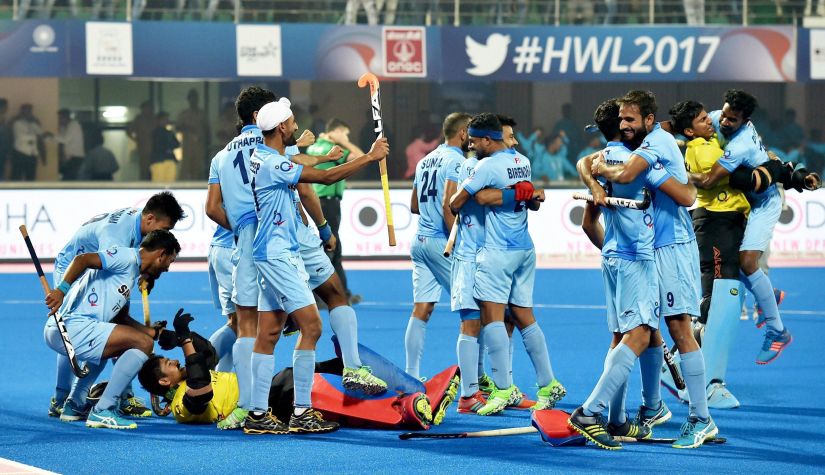 Indian players celebrate after winning their quarter-final match against Belgium in a penalty shootout during Hockey World League Final at Kalinga Stadium in Bhubaneswar. PTI
