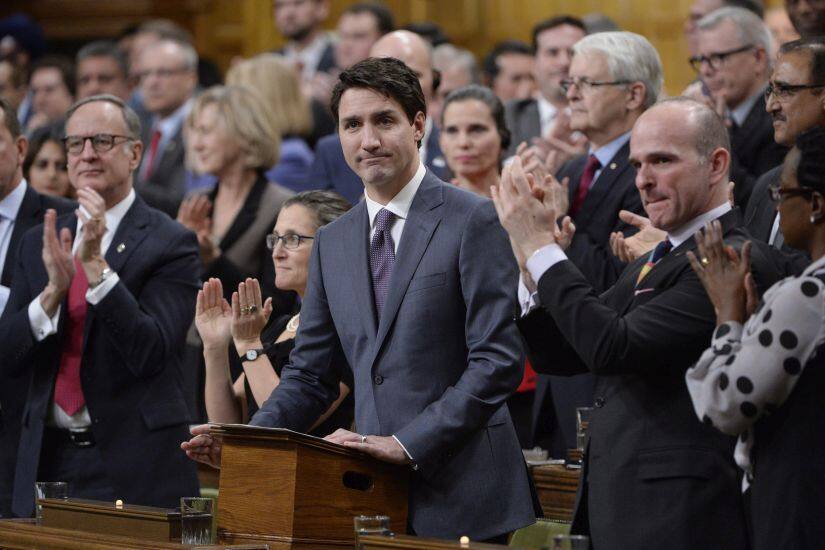Prime Minister Justin Trudeau is applauded as he makes a formal apology to individuals harmed by federal legislation, policies, and practices that led to the oppression of and discrimination against LGBTQ2 people in Canada, in the House of Commons in Ottawa, Tuesday, Nov.28, 2017. (Adrian Wyld/The Canadian Press via AP)