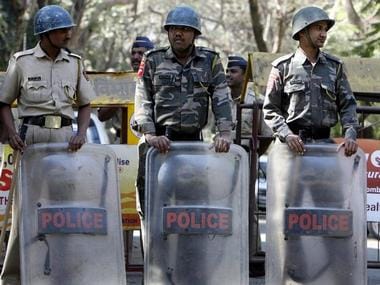 Riot Action Police personnel stand guard on a street during a protest against Maharashtra Navnirman Sena party leader Raj Thackeray in Mumbai February 5, 2008. REUTERS/Punit Paranjpe (INDIA)