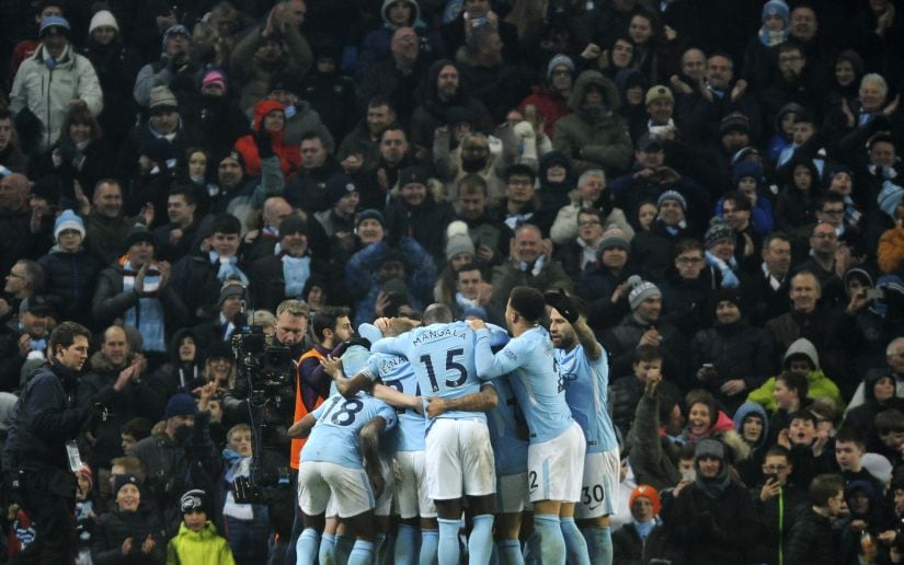 Manchester City players celebrate their team's third goal during the match against Tottenham Hotspur. AP