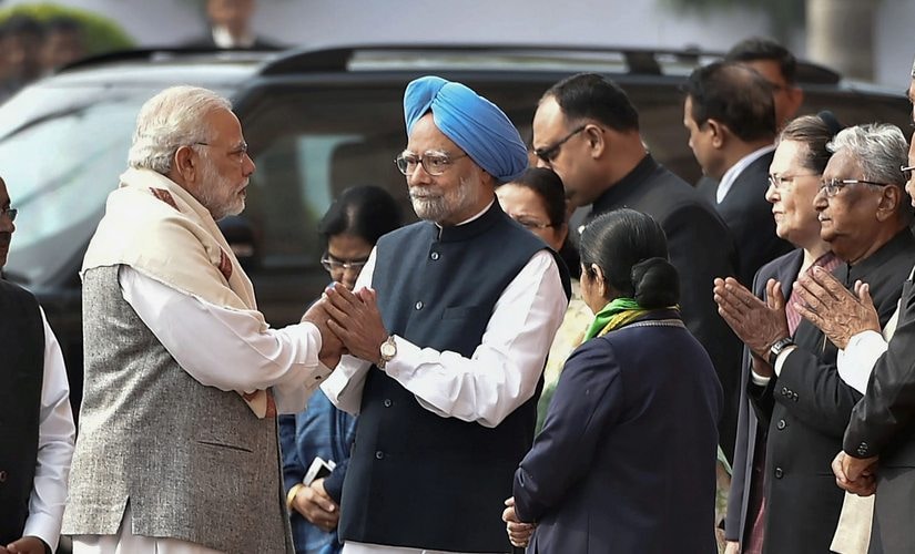 Prime Minister Narendra Modi and former prime minister Manmohan Singh exchange greetings during the tribute paying ceremony for the martyrs of 2001 Parliament attack on its 16th anniversary, at Parliament House. PTI