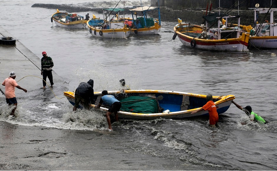 Fishermen pull their boat during high tide in the Arabian Sea in Mumbai. Mumbai police put up barricades near Dadar Chowpatty and Juhu Chowpatty to prevent people from going near the beaches. AP Fishermen pull their boat during high tide in the Arabian Sea in Mumbai. Mumbai police put up barricades near Dadar Chowpatty and Juhu Chowpatty to prevent people from going near the beaches. AP