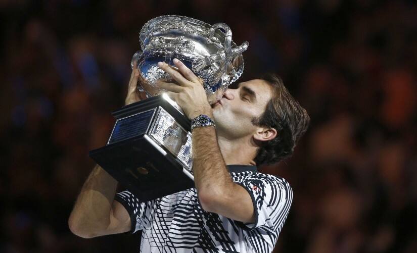 Roger Federer kisses the Australian Open trophy after winning the mens singles final match against Rafael Nadal. Reuters 