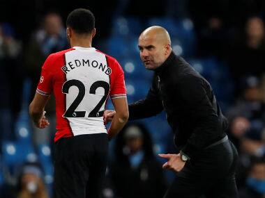 Manchester City manager Pep Guardiola talks to Southampton’s Nathan Redmond, who looks dejected, at the end of the match. Reuters