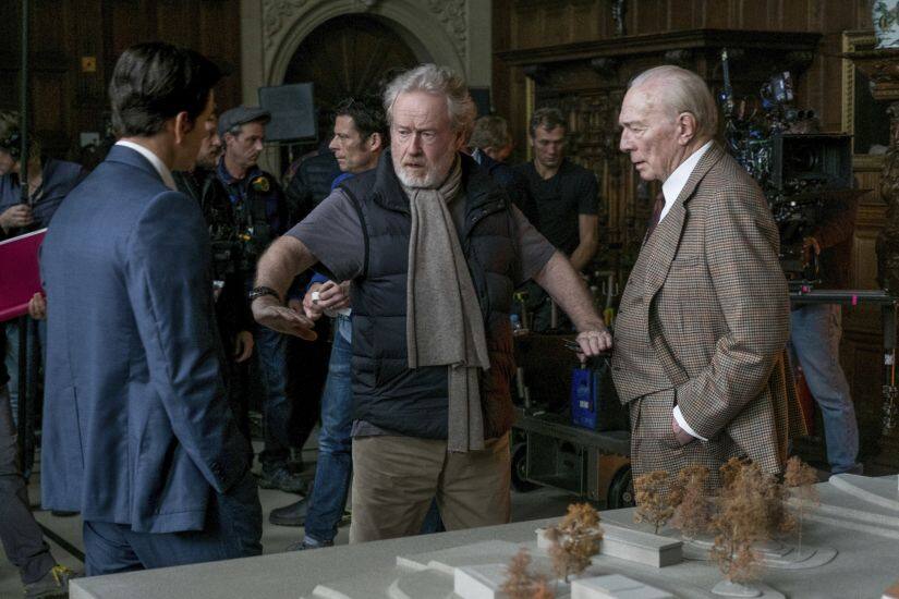 CORRECTS TYPO - FROM CHRISTOPHER DIRECTOR TO CHRISTOPHER PLUMMER -This image released by Sony Pictures shows actors Mark Wahlberg, left, and Christopher Plummer, right, listening to director Ridley Scott on the set of TriStar Pictures’ 