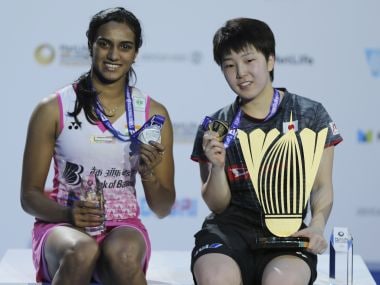 Akane Yamaguchi, right, and India's PV Sindhu pose with their trophies on Sunday. AP