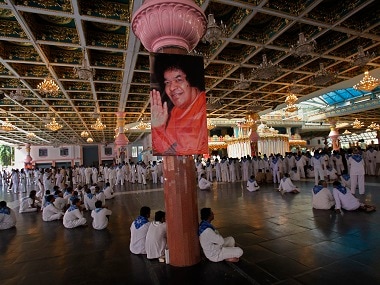 Devotees sit inside the ashram to pay their last respects to Sri Sathya Sai Baba at Puttaparti. Reuters