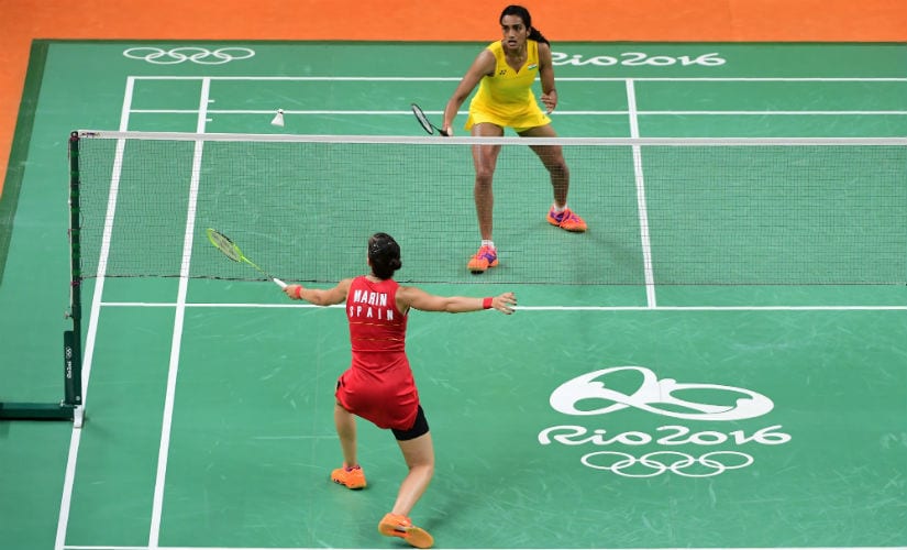 India's PV Sindhu (R) returns against Spain's Carolina Marin during their women's singles final match in Rio. AFP