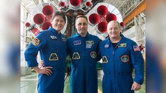 Three crew members representing the United States, Russia and Japan blast off for the International Space Station