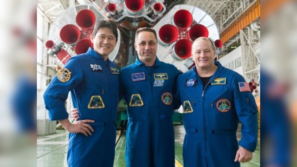 Three crew members representing the United States, Russia and Japan blast off for the International Space Station
