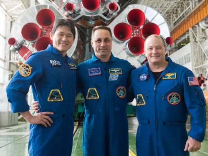 Three crew members representing the United States, Russia and Japan blast off for the International Space Station