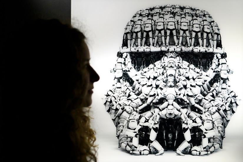 A person looks at a Stormtrooper photograph made by Hyperactives Studio as part of the new exhibition at Maison d' Ailleurs, "Je suis ton pere!". Wednesday, Dec. 6, 2017 in Yverdon. 13 artists revisit the world of Star Wars in the exhibition "I'm your father!" which runs from 10 December 2017 to 14 October 2018. (Laurent Gillieron/Keystone via AP)