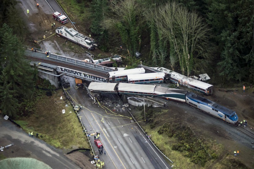 Cars from an Amtrak train that derailed lie spilled onto Interstate 5 on Monday. AP