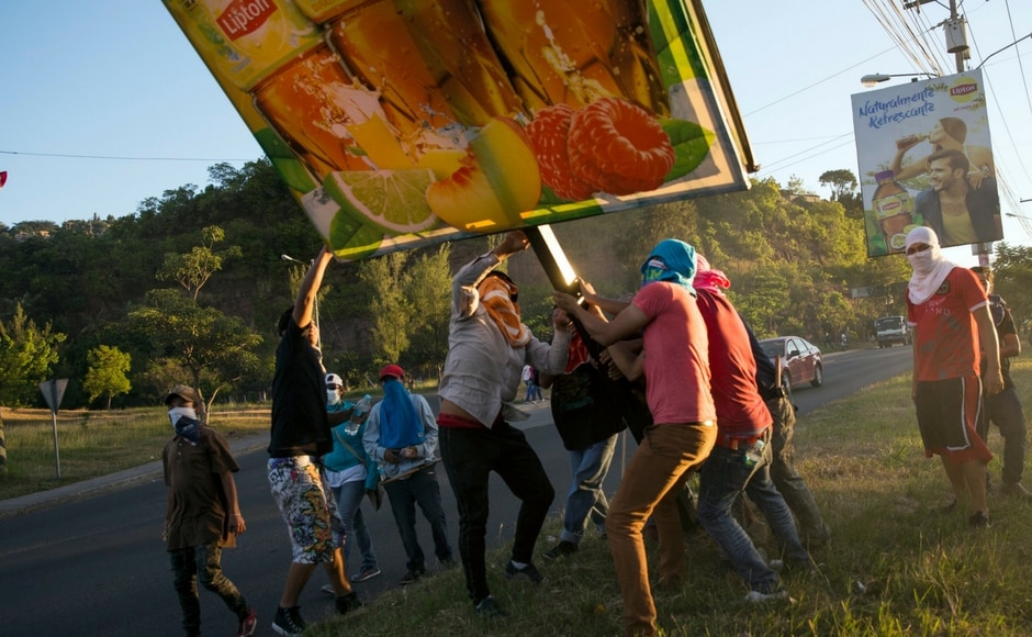Thousands of Hondurans across the country blocked roads with viral footage of confrontations with police, who attempted to disperse demonstrators with tear gas, circulating on social media. AP Thousands of Hondurans across the country blocked roads with viral footage of confrontations with police, who attempted to disperse demonstrators with tear gas, circulating on social media. AP