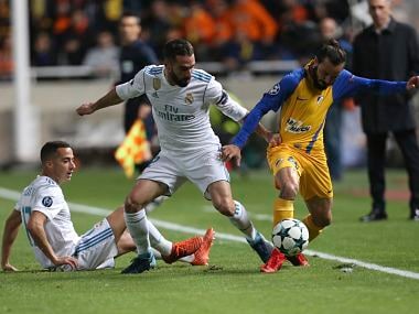 Real Madrid's Daniel Carvaja and his teammate Lucas Vazquez try to stop APOEL's Efstathios Aloneftis during the Champions League Group H match. AP