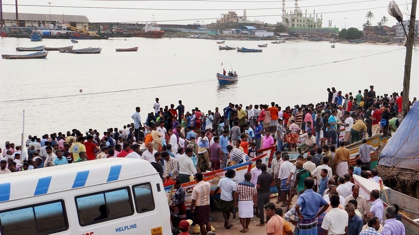 Fishermen families and natives waiting for those who yet to return home at Vizhinjam harbour in Thiruvananthapuram on 2 December. PTI