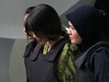 Vietnamese Doan Thi Huong, center, is escorted by police as she leaves the Shah Alam court house after her trial in Shah Alam, outside Kuala Lumpur on Wednesday. AP