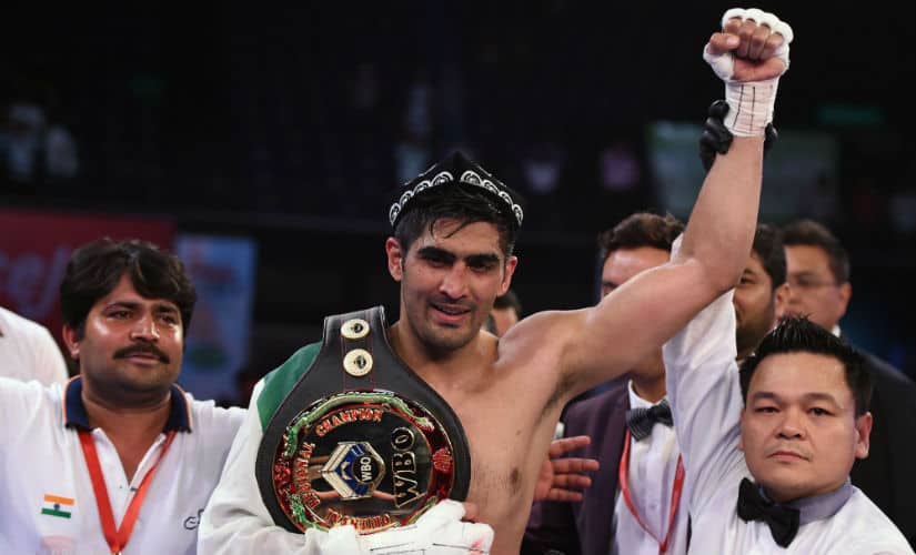 Vijender Singh (C) celebrates after winning the double WBO title bout against China’s Zulpikar Maimaitiali in Mumbai on 5 August, 2017. AFP