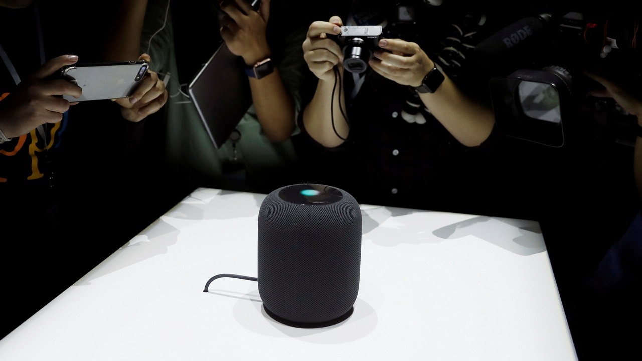 Members of the media photograph a prototype Apple HomePod. Image: Reuters