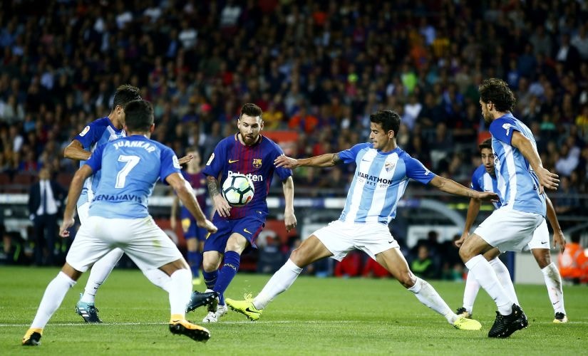 Barcelona's Lionel Messi, center, dribbles between five Malaga defenders in October. AP