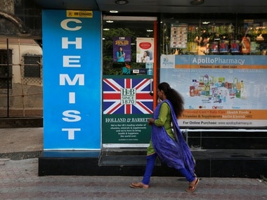 A woman walks past a chemist shop in Mumbai. Image: Reuters