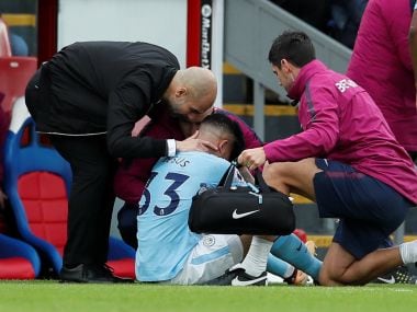 Manchester City manager Pep Guardiola with Manchester City's Gabriel Jesus as he receives medical attention. Reuters