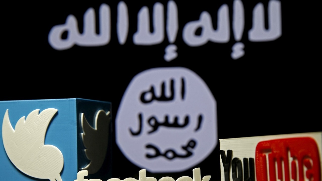 3D plastic representations of the Twitter, Facebook and Youtube logos are seen in front of a displayed ISIS flag in this photo illustration shot February 3, 2016. REUTERS/Dado Ruvic/File Photo - D1BETXLAOLAA