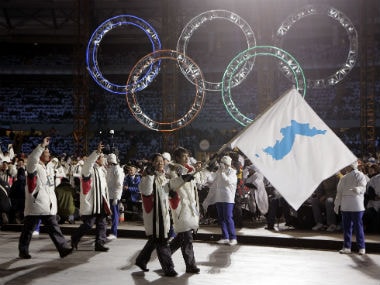 Korea flag-bearer's Bora Lee and Jong-In Lee, carrying a unification flag lead their teams into the stadium during the 2006 Winter Olympics opening ceremony in Turin, Italy. AP