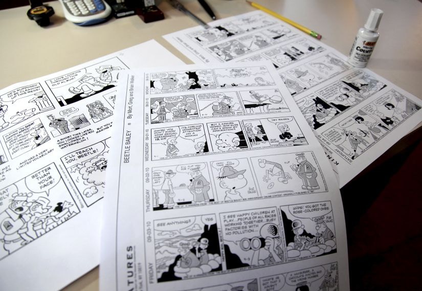 FILE - In this Aug. 16, 2010 file photo, Beetle Bailey comic strips that will be published in the coming weeks rest on a desk in the studio of creator Mort Walker in Stamford, Conn. On Saturday, Jan. 27, 2018, a family member said the comic strip artist has died. He was 94. (AP Photo/Craig Ruttle)