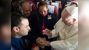 Pope Francis performs impromptu marriage ceremony for two flight attendants on airplane in Chile