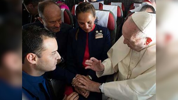 Pope Francis performs impromptu marriage ceremony for two flight attendants on airplane in Chile