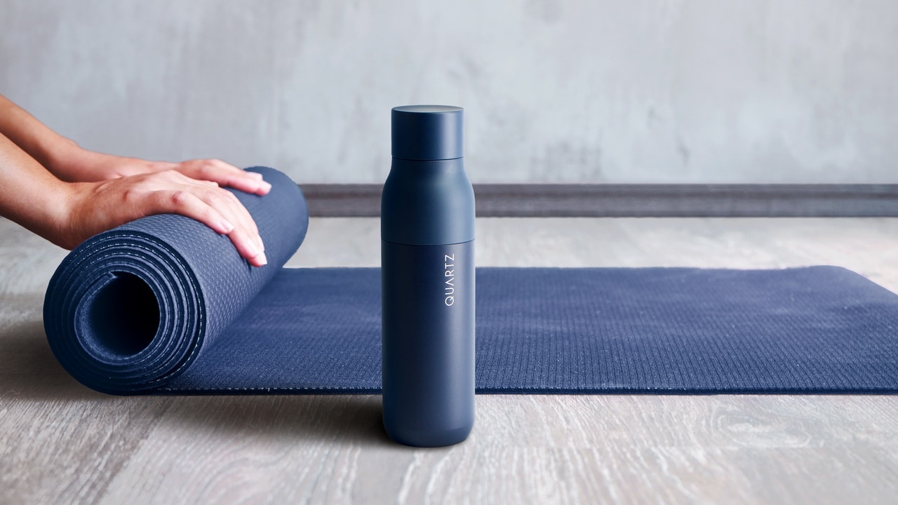 Woman rolling her mat after a yoga class.