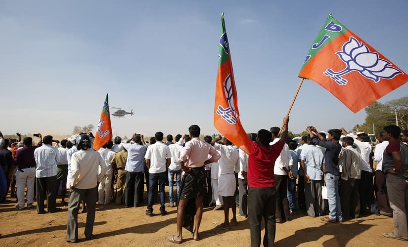 The crowd at the rally cheers for Amit Shah. 