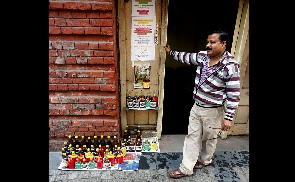 A vendor displaying organic honey at his little shop set up by the 17th century Writers' Building, one of nearly 3,00,000 city structures dating back to Britain's rule over India. Image from AP A vendor displaying organic honey at his little shop set up by the 17th century Writers' Building, one of nearly 3,00,000 city structures dating back to Britain's rule over India. Image from AP