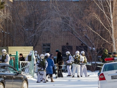 Armed police officers block an area around a school in Sosnovy Bor on the outskirts of Ulan-Ude. AP