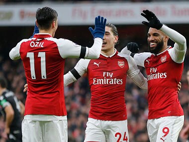 Arsenal's Mesut Ozil, Hector Bellerin and Alexandre Lacazette celebrate after Lacazette scored their side's fourth goal against Crystal Palace. AP