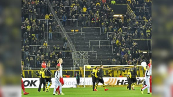 Bundesliga: Borussia Dortmund held by Augsburg as fans boycott match to protest against Monday football