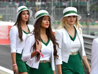 Grid girls walk along at the Silverstone circuit during last season's British Grand Prix. AFP