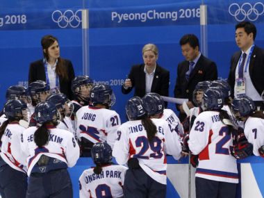 Korea head coach Sarah Murray talks to the joint Korean ice hockey team during their match against Switzerland on 10 February. Reuters
