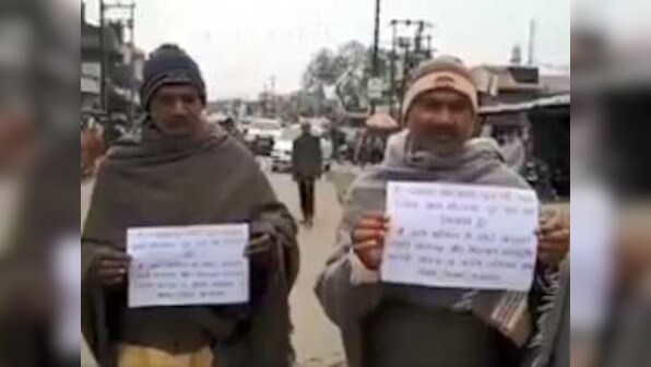 Former Uttar Pradesh prisoners walk with placards pledging to reform and not 'indulge in crime again'