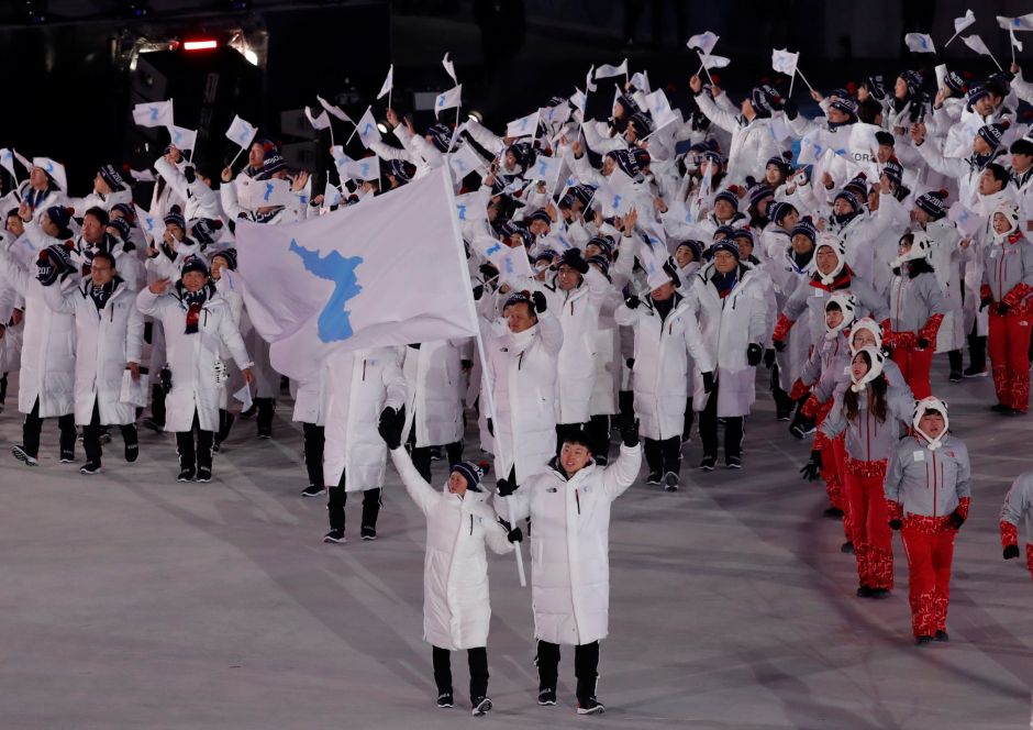 Hwang Chung Gum and Won Yunjong of Korea carry the national flag. Athletes from North and South Korea marches together under one flag. Reuters Hwang Chung Gum and Won Yunjong of Korea carry the national flag. Athletes from North and South Korea marches together under one flag. Reuters
