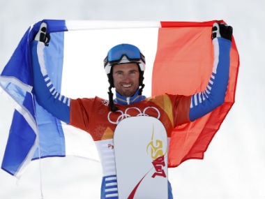 Gold medallist Pierre Vaultier of France carries the French flag as he celebrates. Reuters