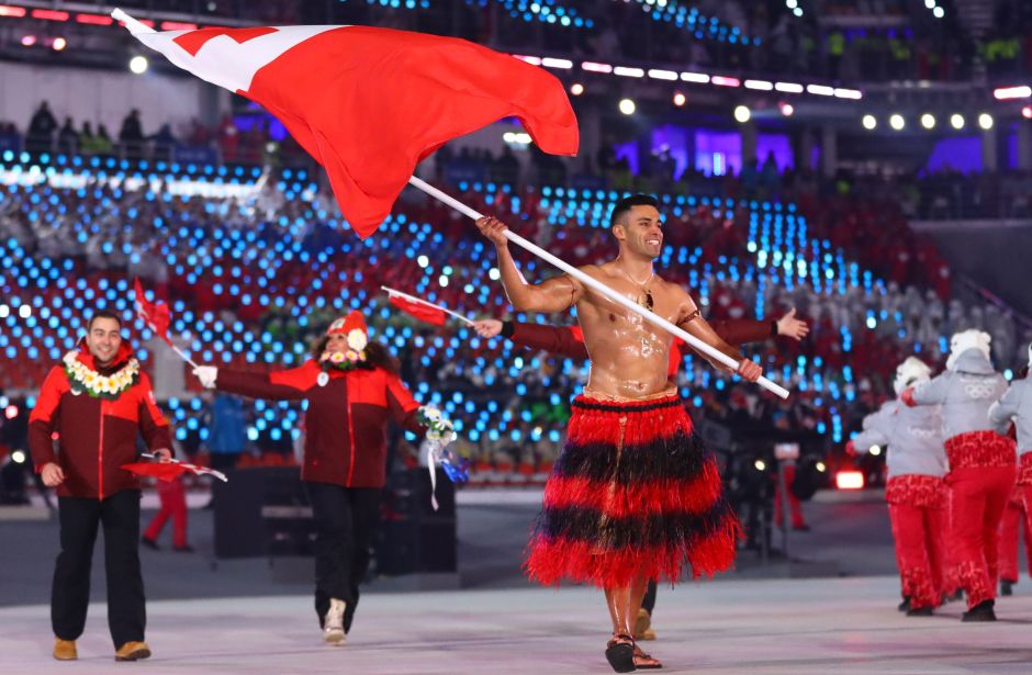 Pita Taufatofua of Tonga carries the national flag with delegates. One of the biggest cheers was reserved for muscle-bound Tongan Taufatofua, who repeated his famed Rio Games entrance by marching in shirtless, oiled up and wearing a traditional skirt -- this time in sub-zero temperatures. Reuters Pita Taufatofua of Tonga carries the national flag with delegates. One of the biggest cheers was reserved for muscle-bound Tongan Taufatofua, who repeated his famed Rio Games entrance by marching in shirtless, oiled up and wearing a traditional skirt -- this time in sub-zero temperatures. Reuters