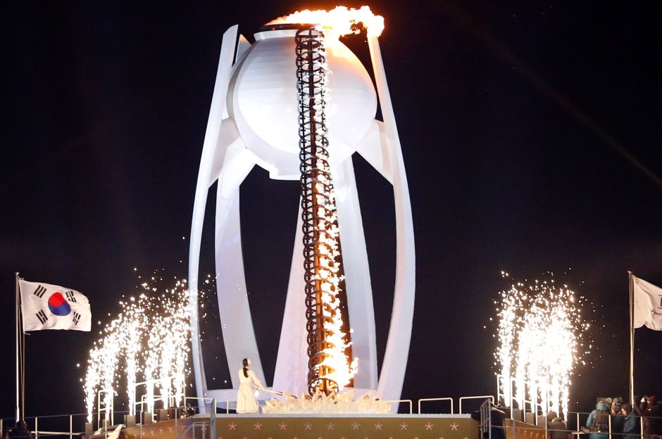 Former figure skater Yuna Kim of South Korea lights the cauldron during the opening ceremony. Reuters Former figure skater Yuna Kim of South Korea lights the cauldron during the opening ceremony. Reuters