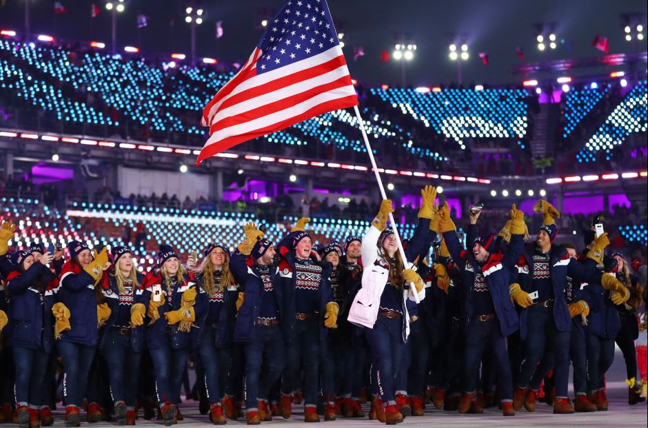 Erin Hamlin of US carries the national flag with delegates during the opening ceremony. When the American athletes walked in, the Korean pop hit Gangnam Style blared around the stadium, sparking the ‘Horse Dance’ in the crowd and among the volunteers. Reuters Erin Hamlin of US carries the national flag with delegates during the opening ceremony. When the American athletes walked in, the Korean pop hit Gangnam Style blared around the stadium, sparking the ‘Horse Dance’ in the crowd and among the volunteers. Reuters