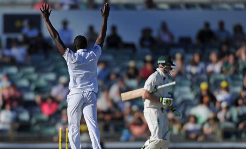 South Africa’s Kagiso Rabada (L) celebrates dismissing Australia’s Steve Smith (R) on day four of the first Test cricket match between Australia and South Africa in Perth on November 6, 2016. / AFP PHOTO / Greg Wood / IMAGE RESTRICTED TO EDITORIAL USE - STRICTLY NO COMMERCIAL USE