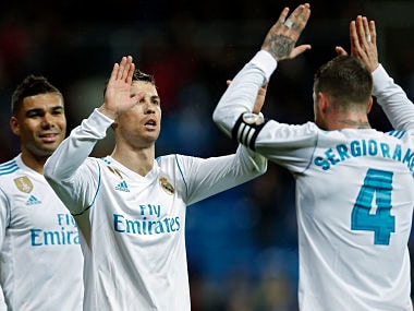 Real Madrid's Cristiano Ronaldo, centre, celebrates with teammate Sergio Ramos after scoring his side's third goal against Getafe during the Spanish La Liga soccer match between Real Madrid and Getafe at the Santiago Bernabeu stadium in Madrid, Saturday, March 3, 2018. Ronaldo scored twice in Real Madrid's 3-1 victory. (AP Photo/Francisco Seco)