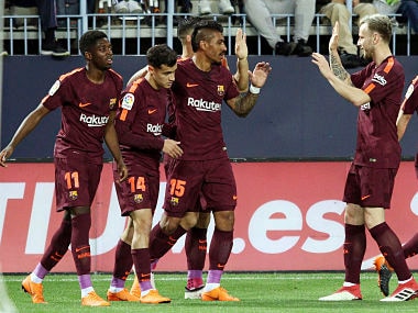 Barcelona's Coutinho celebrates with team mates scoring his side's 2nd goal during a Spanish La Liga soccer match between Malaga and Barcelona in Malaga, Spain, Saturday, March 10, 2018. (AP Photo/M.Pozo)